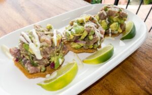 Tuna tostadas piled high with ahi tuna, avocado, and cream sauce