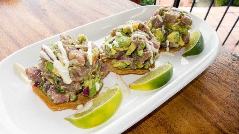 Tuna tostadas piled high with ahi tuna, avocado, and cream sauce