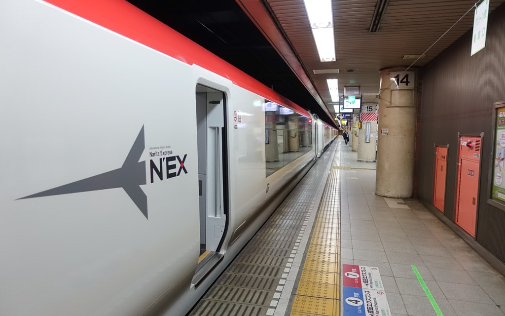 Narita Express train (N'EX)  passing through a station in Tokyo