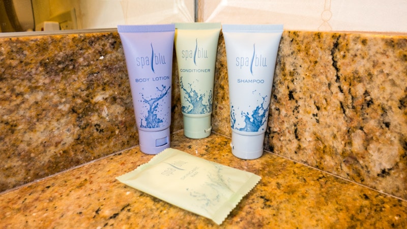 Complementary toiletries: body lotion, conditioner, shampoo, and a bar of soap
