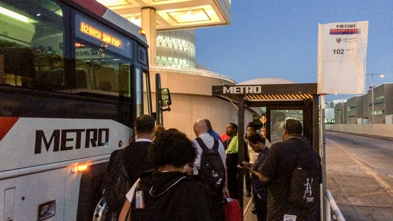 Passengers boarding Bus 102 towards downtown Houston