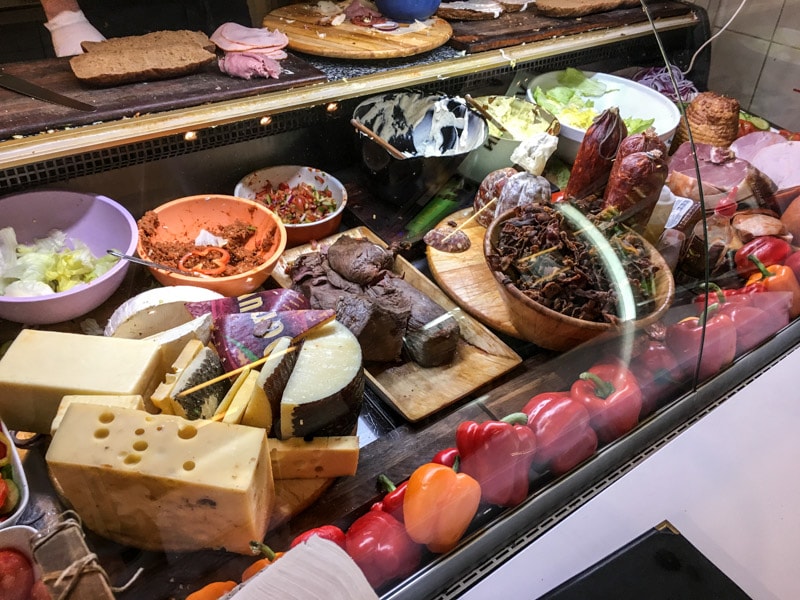 Colorful deli counter packed with meats and cheeses