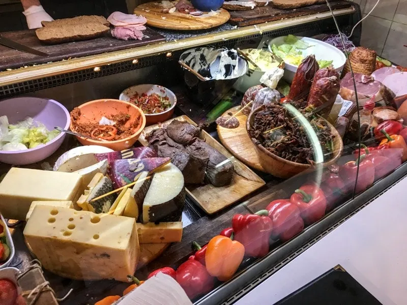 Colorful deli counter packed with meats and cheeses