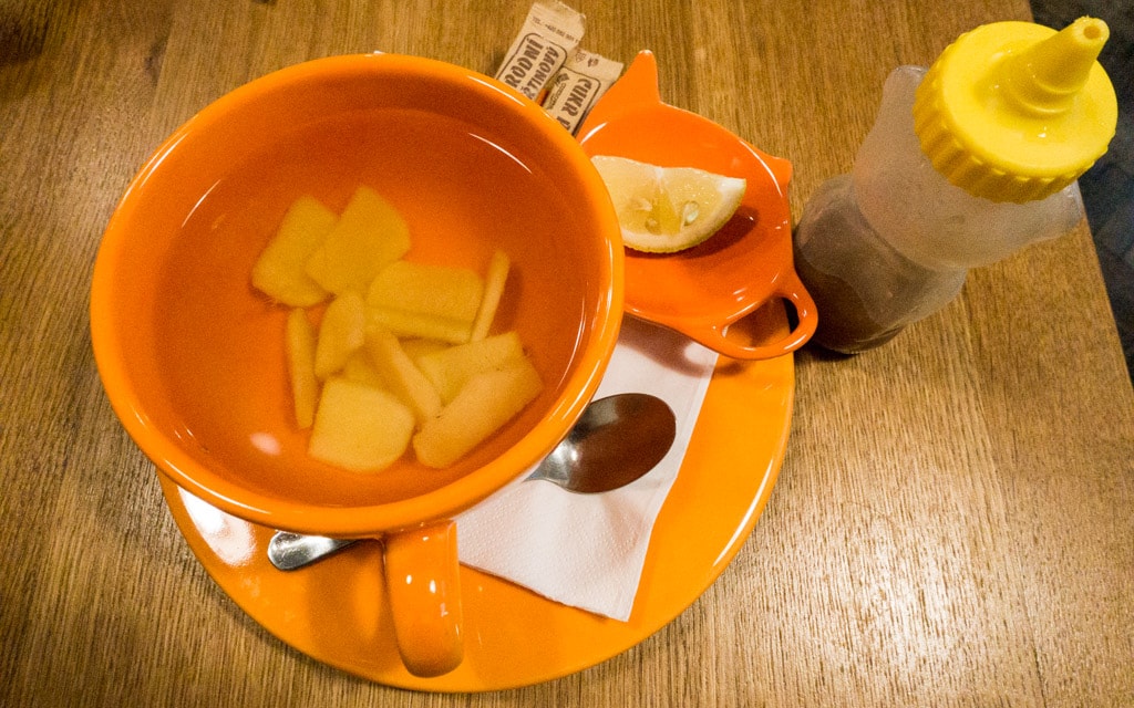 Hot ginger tea with lemon and honey on the side
