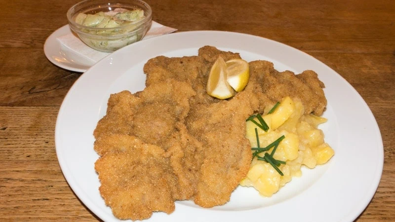 Wiener Schnitzel with potato salad and cucumber salad on the side from Prater Gaststätte, Berlin