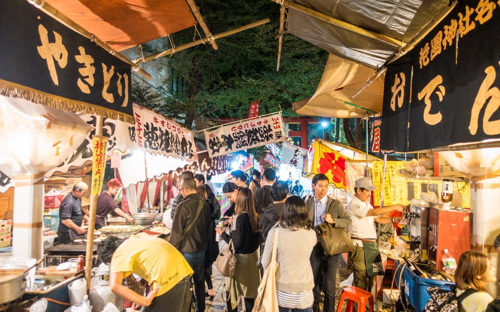 Street food vendors packing the grounds of the shrine