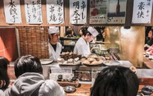 Chefs grilling meats over charcoal, Kushiwakamaru Honten, Tokyo, Japan