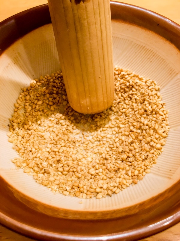 Grinding sesame seeds into a paste, Katsukura, Kyoto, Japan