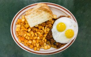 The Green Chili Hash with a side of potatoes and sourdough bread