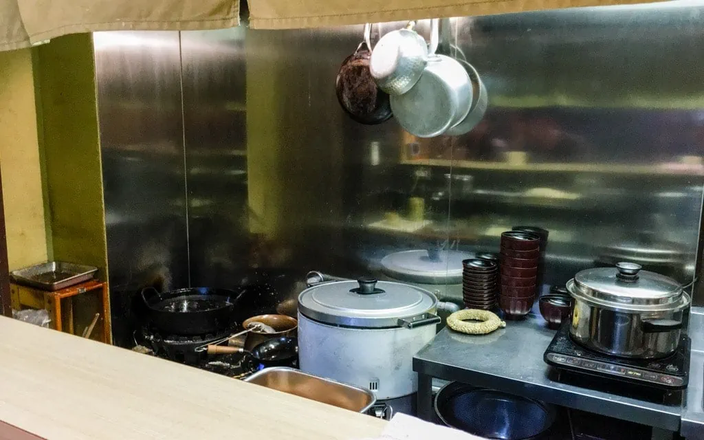 Small, cramped kitchen behind the counter, Katsudonya Zuicho, Tokyo, Japan