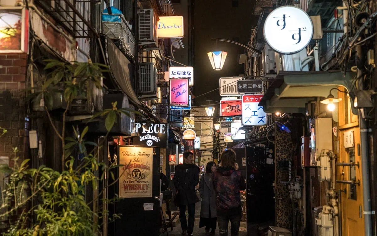 Walking past tiny bars found in Golden Gai, Shinjuku, Tokyo, Japan