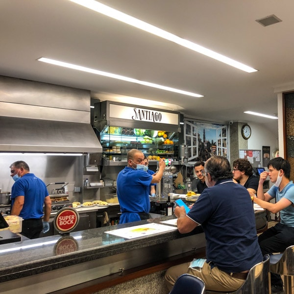 Staff pouring drinks at the bar, Café Santiago, Porto, Portugal