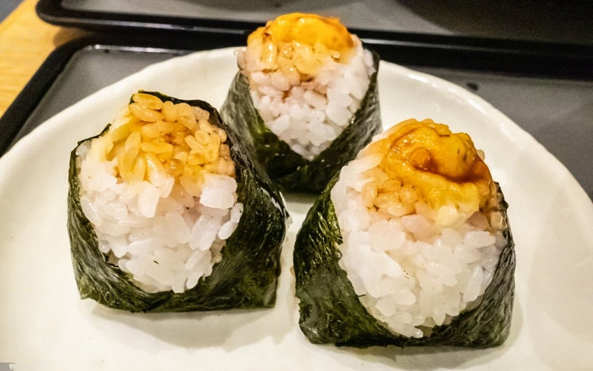 Tenmusu is a delicious snack of tempura shrimp, rice, and nori