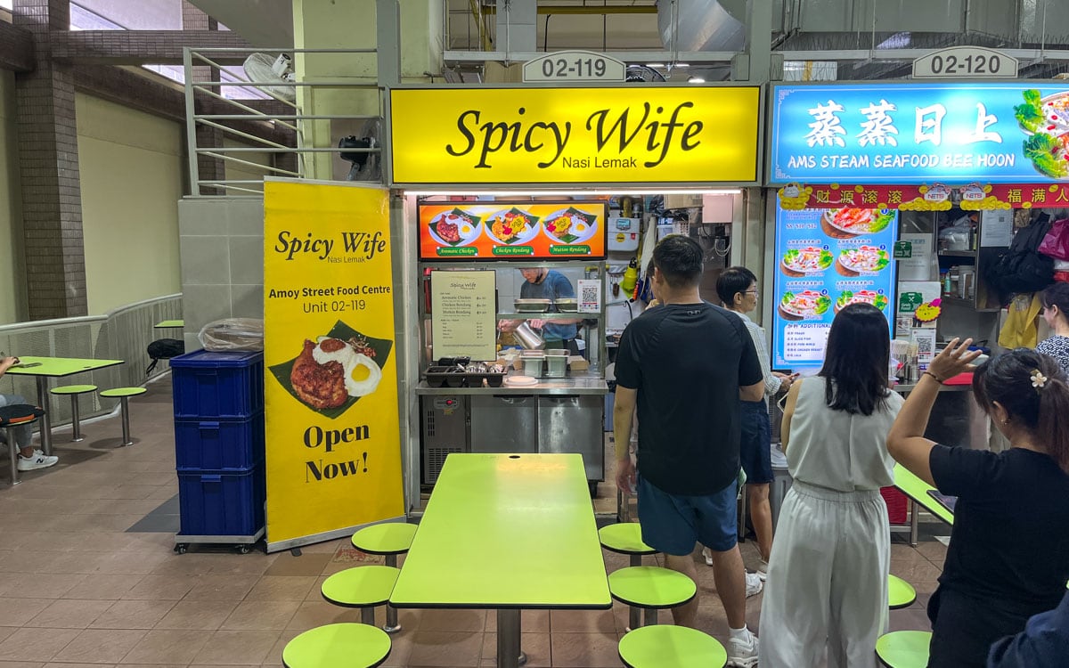 People waiting in line in front of Spicy Wife Nasi Lemak at Amoy Street Food Centre in Singapore waiting to order